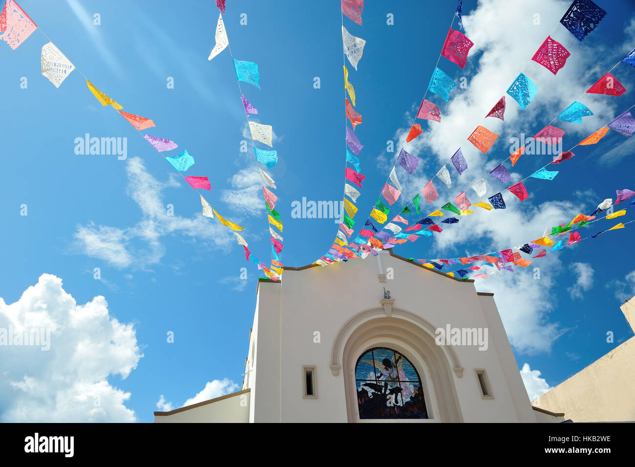 Colorfull flag on blue sky background Stock Photo - Alamy
