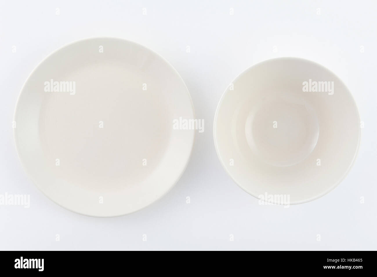 two empty white plates on white background Stock Photo