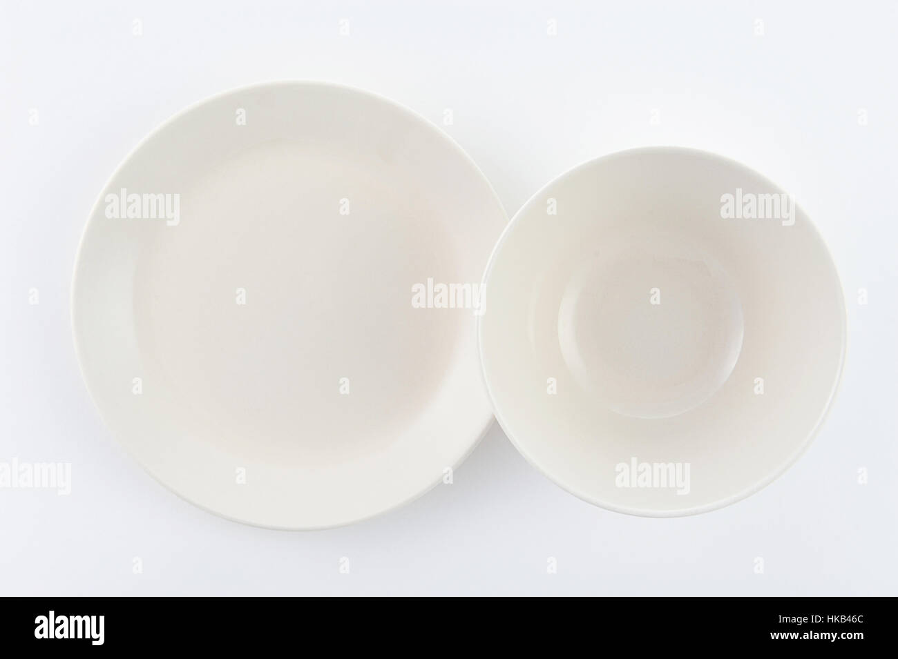 two empty plate on white background Stock Photo - Alamy