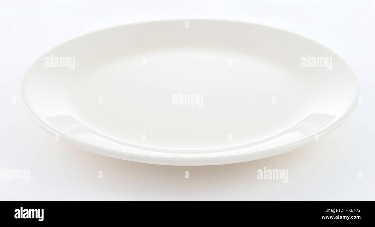 round empty white plate on white background Stock Photo