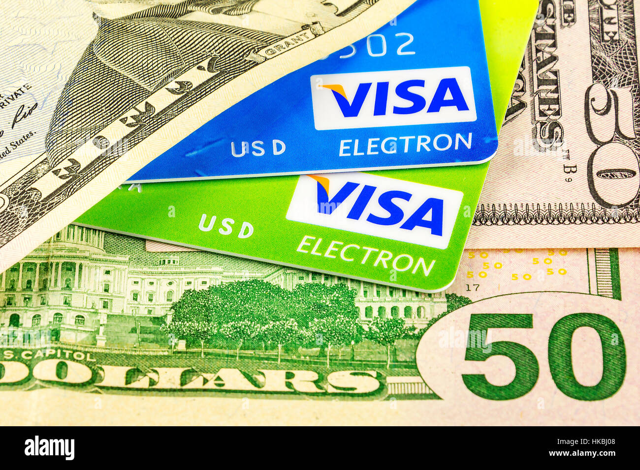 Part of the bank card payment system Visa and Parts dollar bills of different denomination Stock Photo