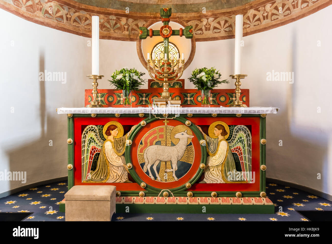 Altar with two angels and the Lamb of God On the altar is a seven-branched candlestick, Tveje Merlose, Denmark - January 23, 2017, Stock Photo