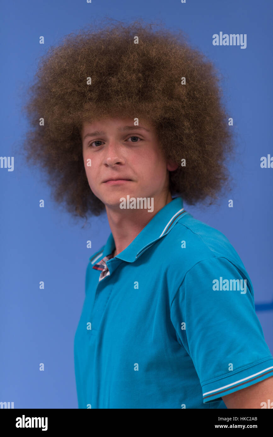 Portrait Of A Young Man With A Funky Hairstyle With Arms