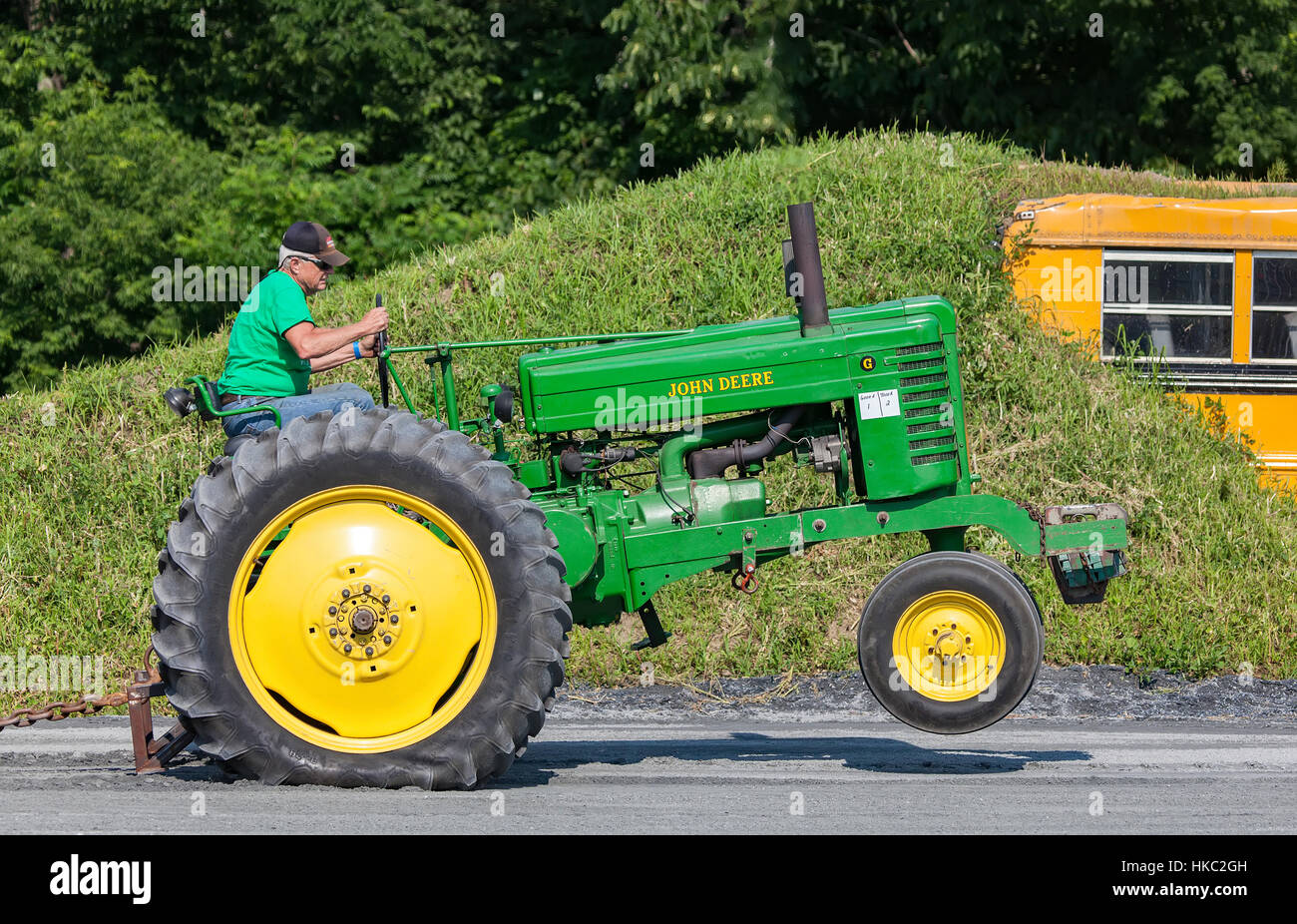 Antique John Deere G tractor does a wheelie pulling a weighted sled at the annual Connecticut Valley Fair in Bradford, VT, USA. Stock Photo