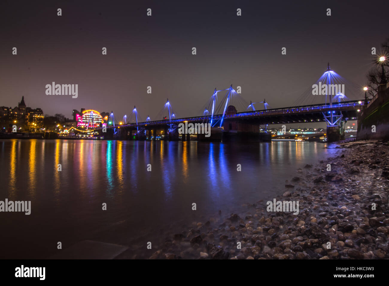 Hungerford and golden Jubilee bridge as seen from Thames river beach at low tide Stock Photo