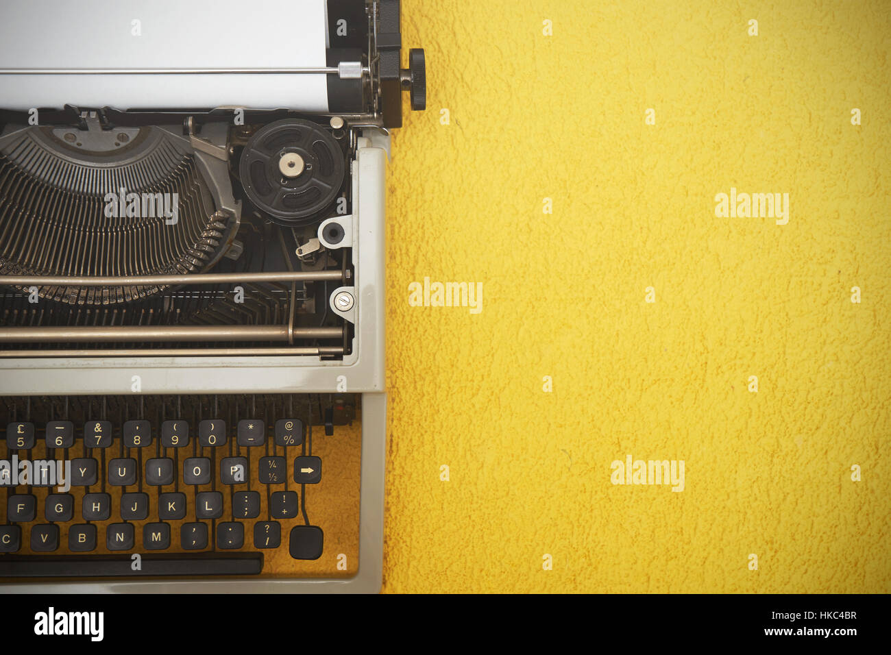 Vintage typewriter on yellow background Stock Photo - Alamy