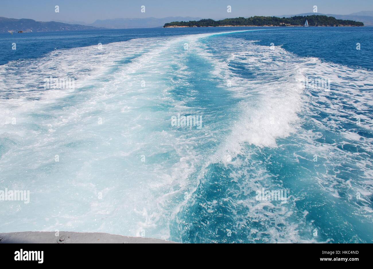 The wake from the stern of a high speed hydrofoil ferry entering Kerkira harbour on the Greek island of Corfu. Stock Photo