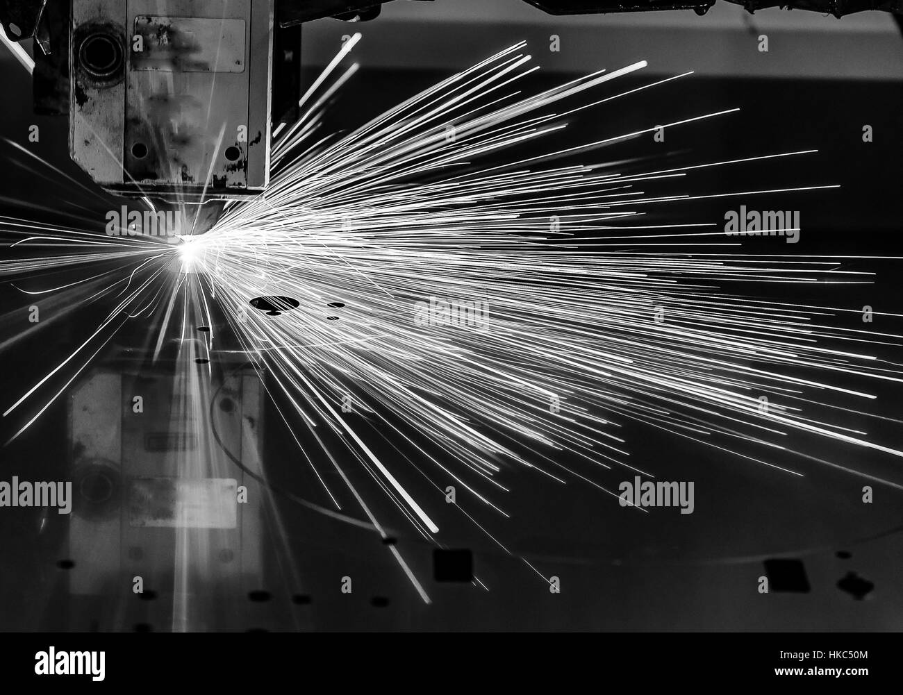 Industrial Laser cutting processing manufacture technology of flat sheet metal steel material with sparks laser cut metal splashes Stock Photo