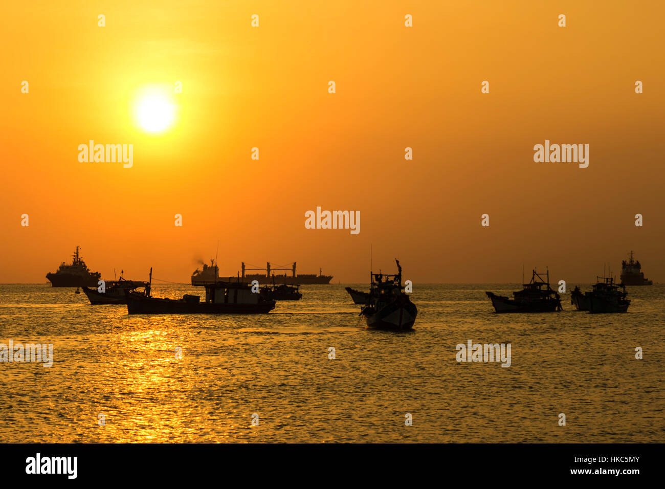 wooden boats silhouettes on a sunset background Stock Photo - Alamy