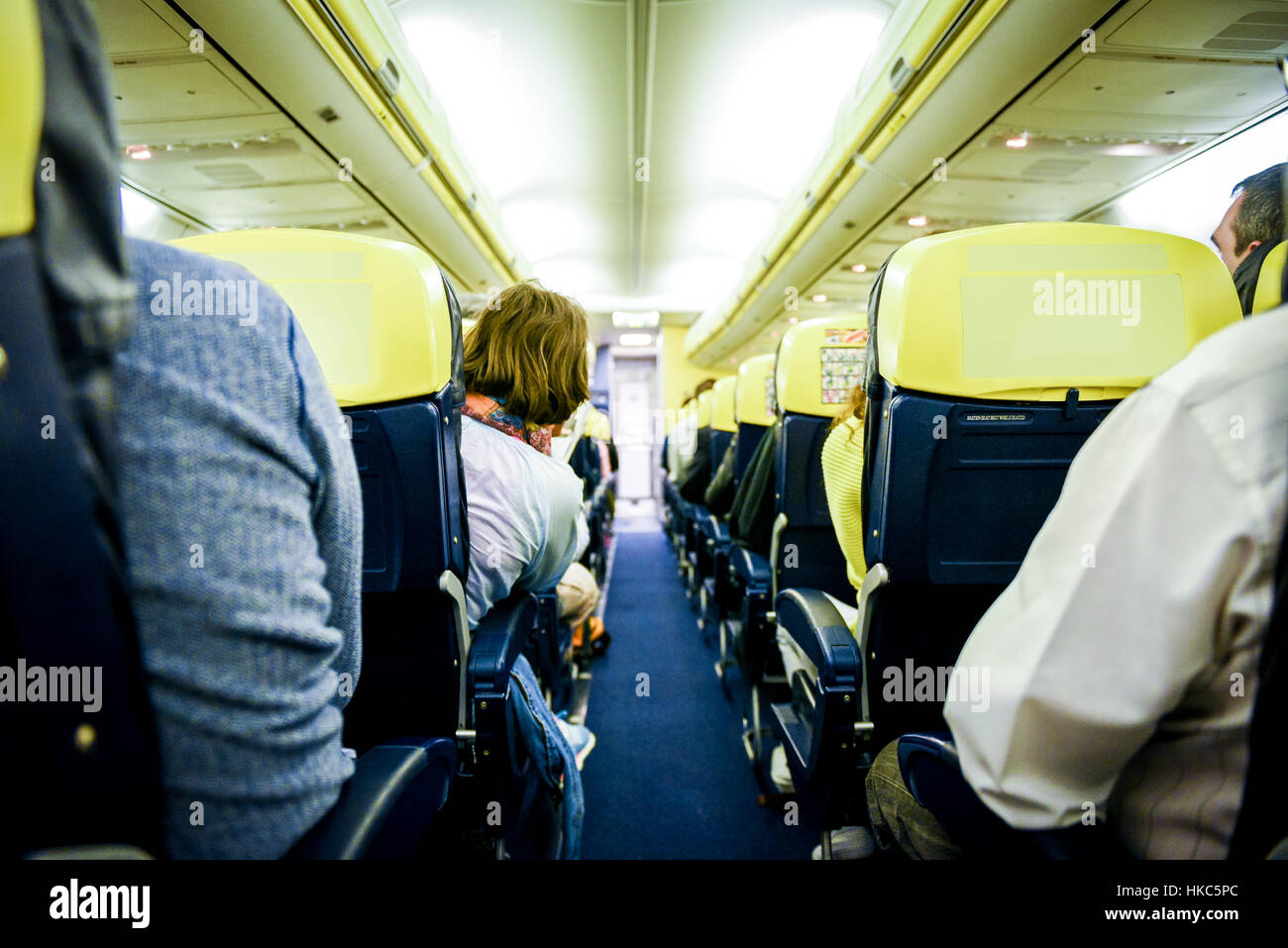 People sitting in aircraft. Rows of sits on a airlines passenger jet