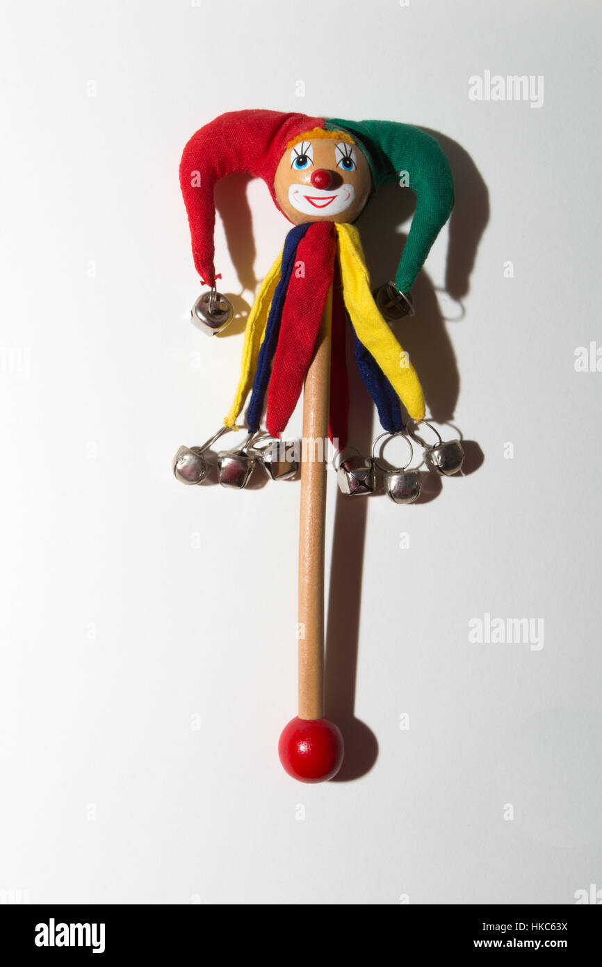 A fool or jester adorns a rattle with bells. Stock Photo