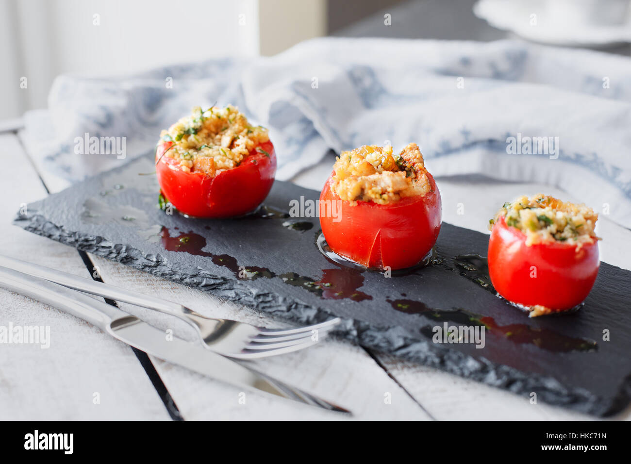 Tomato stuffed with cous cous. Vegetarian healthy food Stock Photo