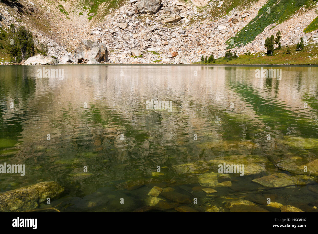 Holly Lake reflecting the rocky mountainsides of upper Paintbrush