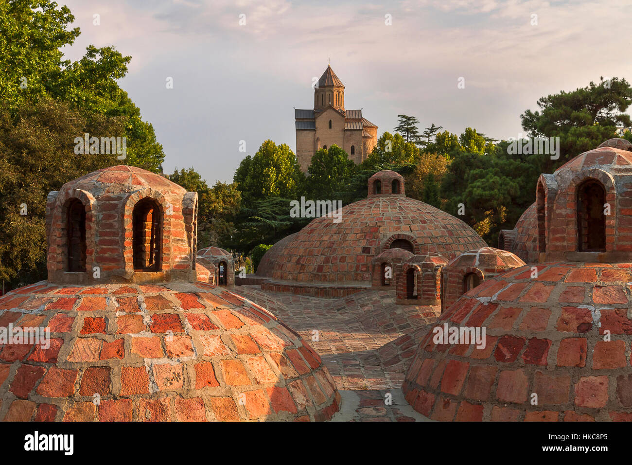 Domes of a Georgian thermal bath and Metekhi Church in Tbilisi, Georgia Stock Photo