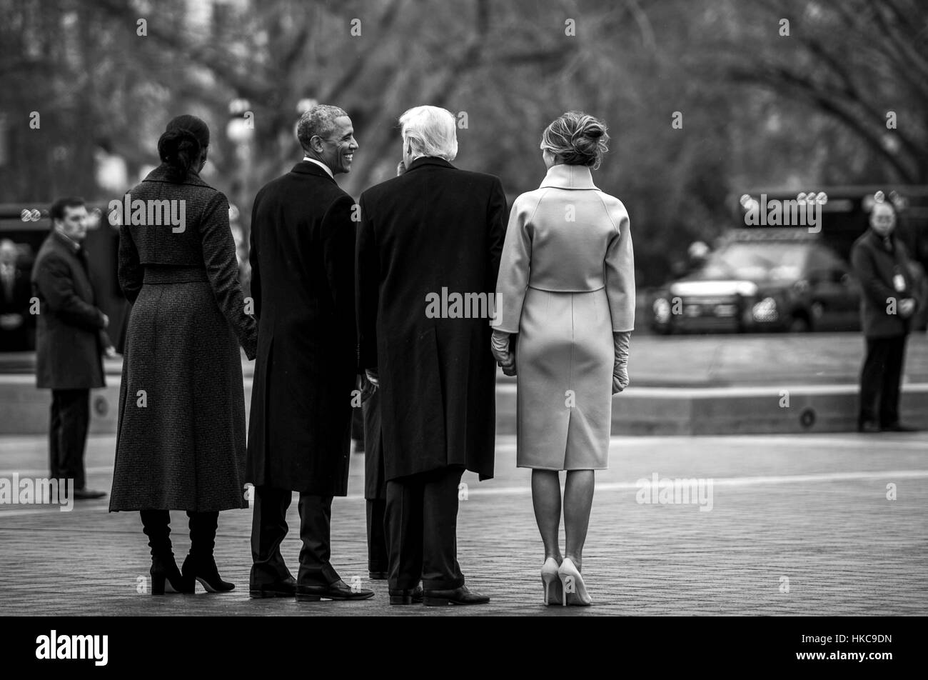 U.S. President Donald Trump, First Lady Melania Trump, former President Barack Obama, and former First Lady Michelle Obama walk toward the Executive One aircraft during the departure ceremony at the 58th Presidential Inauguration January 20, 2017 in Washington, DC. Stock Photo