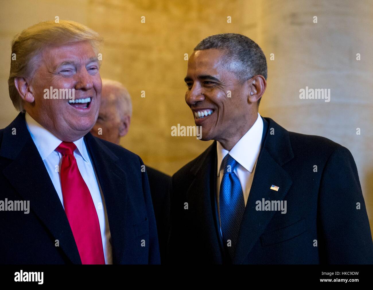U.S. President Donald Trump and former President Barack Obama share a laugh as they wait to exit the east steps for the departure ceremony during the 58th Presidential Inauguration at the U.S. Capitol January 20, 2017 in Washington, DC. Stock Photo
