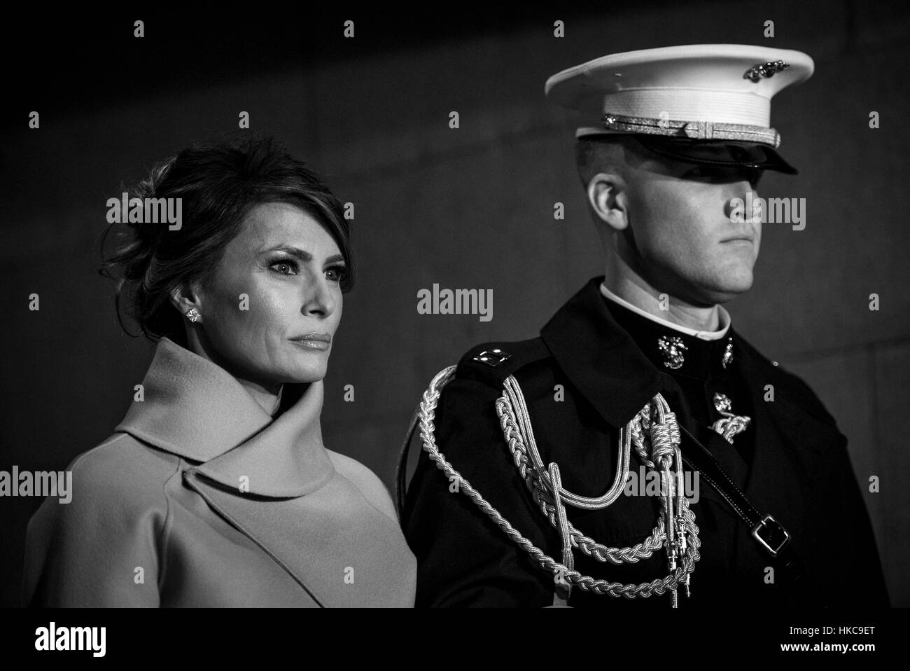 A U.S. Marine soldier escorts First Lady Melania Trump toward the U.S. Capitol platform during the 58th Presidential Inauguration January 20, 2017 in Washington, DC. Stock Photo