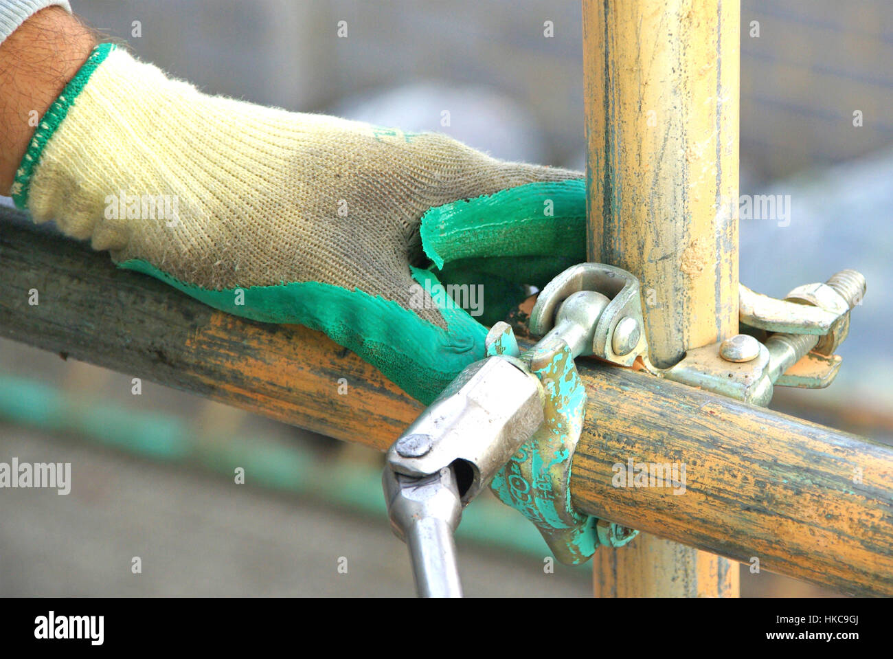 Scaffolding tools close up glove hand using spanner close up concept