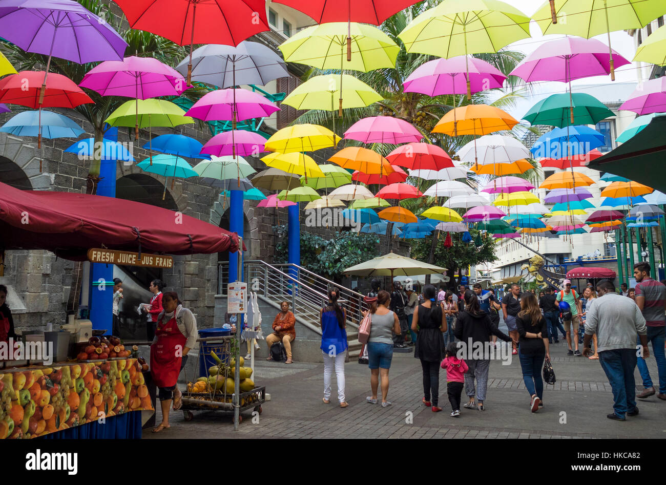 Floating umbrella art display in street at Caudan Waterfront, Port Luis