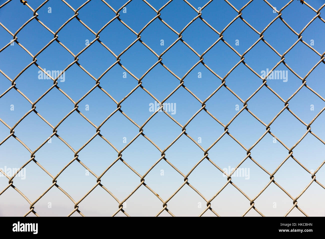 Fence rabitz closeup on blue sky background Stock Photo - Alamy