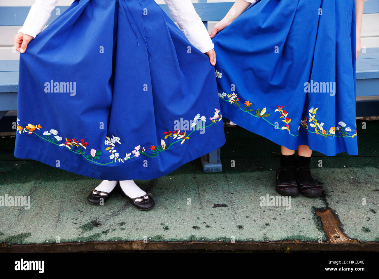 Close up of women's skirts of two Norwegian folk dancers, Southeast Alaska, USA Stock Photo