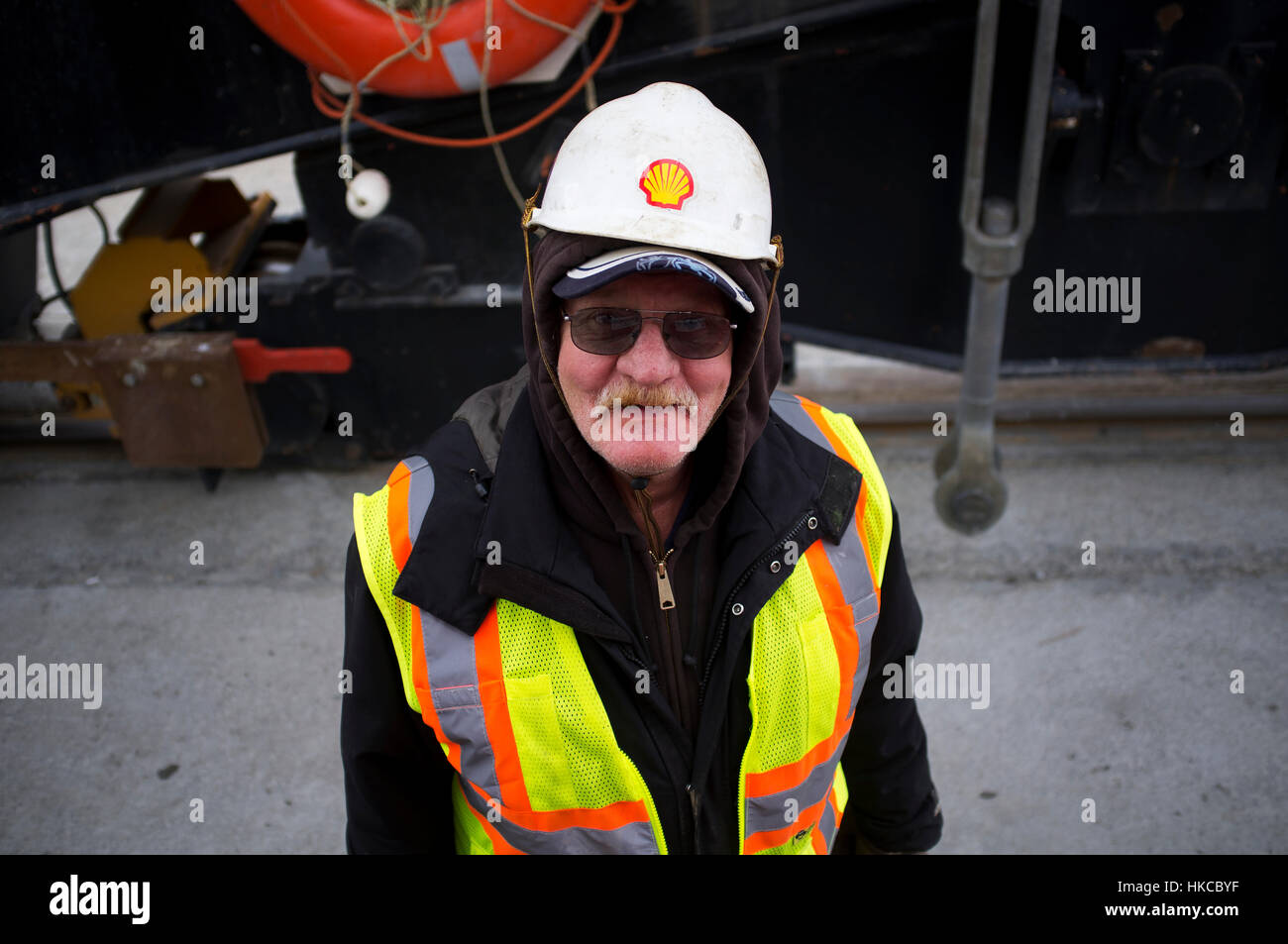 Longshoreman working on the Unalaska Marine Center dock during Horizon Lines operations in Unalaska, Southwest Alaska, USA Stock Photo