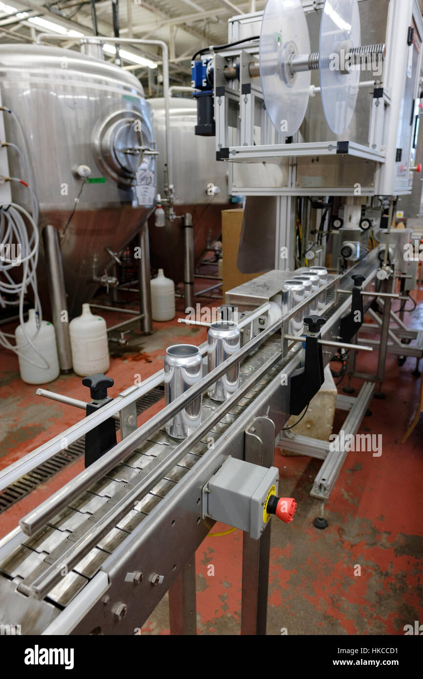 Beer labelling line with aluminum can blanks at Railway City Brewing Co., a microbrewery located in St Thomas, Ontario, Canada. Stock Photo