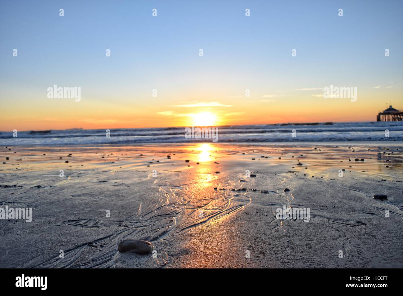 Sun set at Imperial Beach, San Diego, California. Low angle shot on sand. Stock Photo