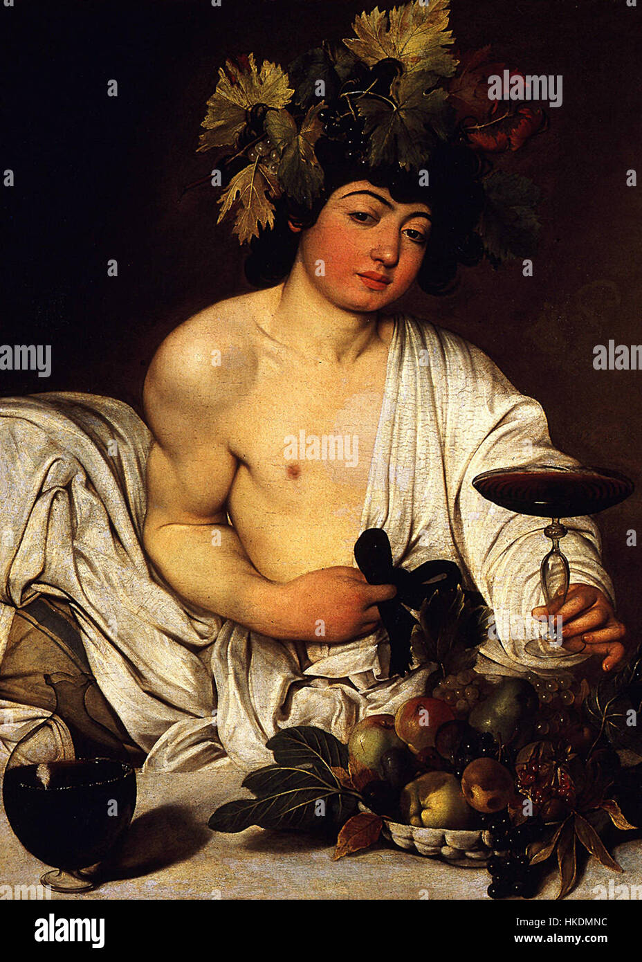 Caravaggio's 'Bacchus' captures the Roman god of wine in a vivid and dramatic portrait. The painting is renowned for its use of light and shadow, characteristic of the Baroque style, and offers a naturalistic depiction of the mythological figure. Stock Photo