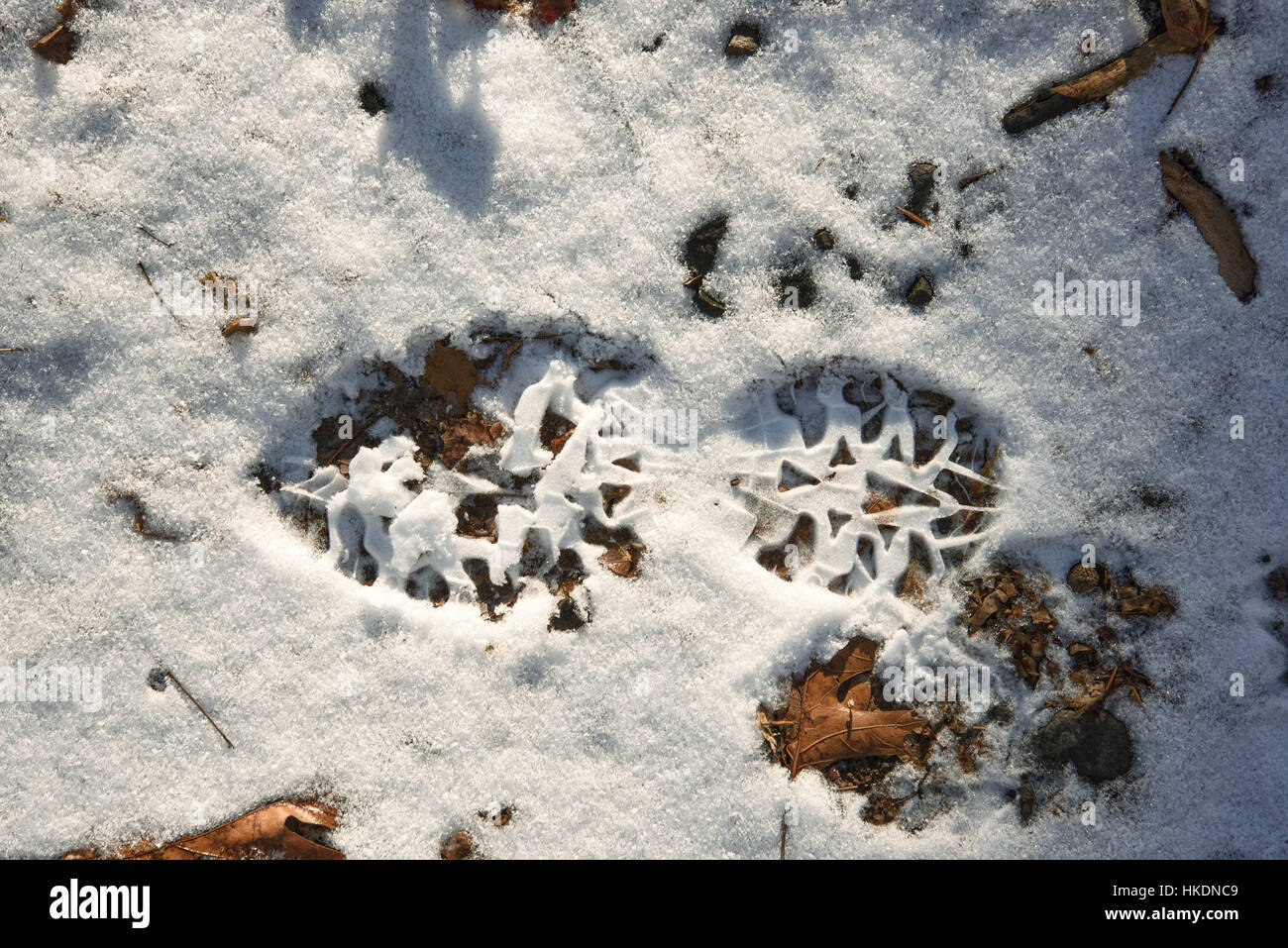 A footprint in the snow left by a hiker or runner Stock Photo