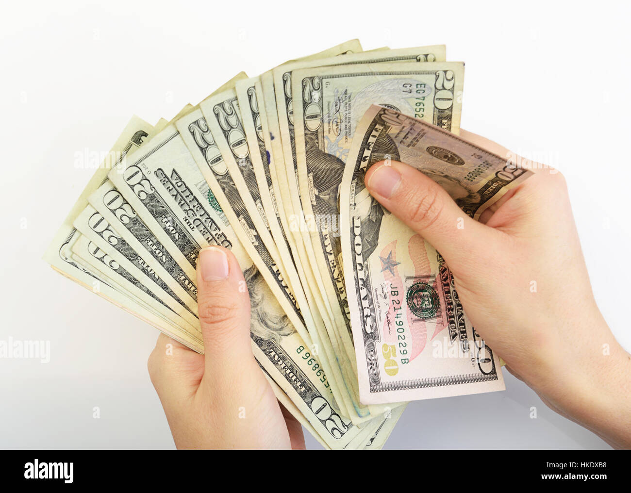 person with hands counting dollars on white background Stock Photo
