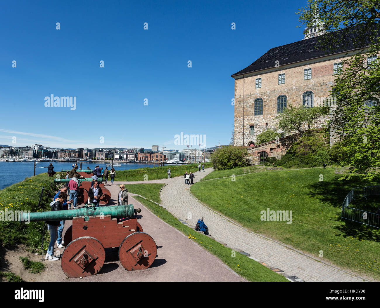 OSLO, NORWAY - MAY 16, 2016: Tourists watch the old canon in front of the Akershus Fortress in Oslo. This is one of the Norwegian capital city main la Stock Photo
