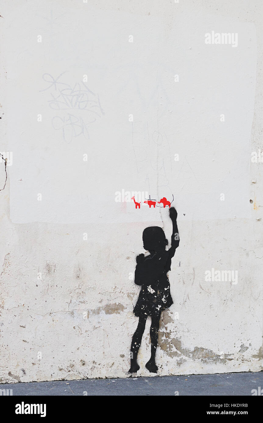 Graffiti of boy drawing animals on white wall Stock Photo - Alamy
