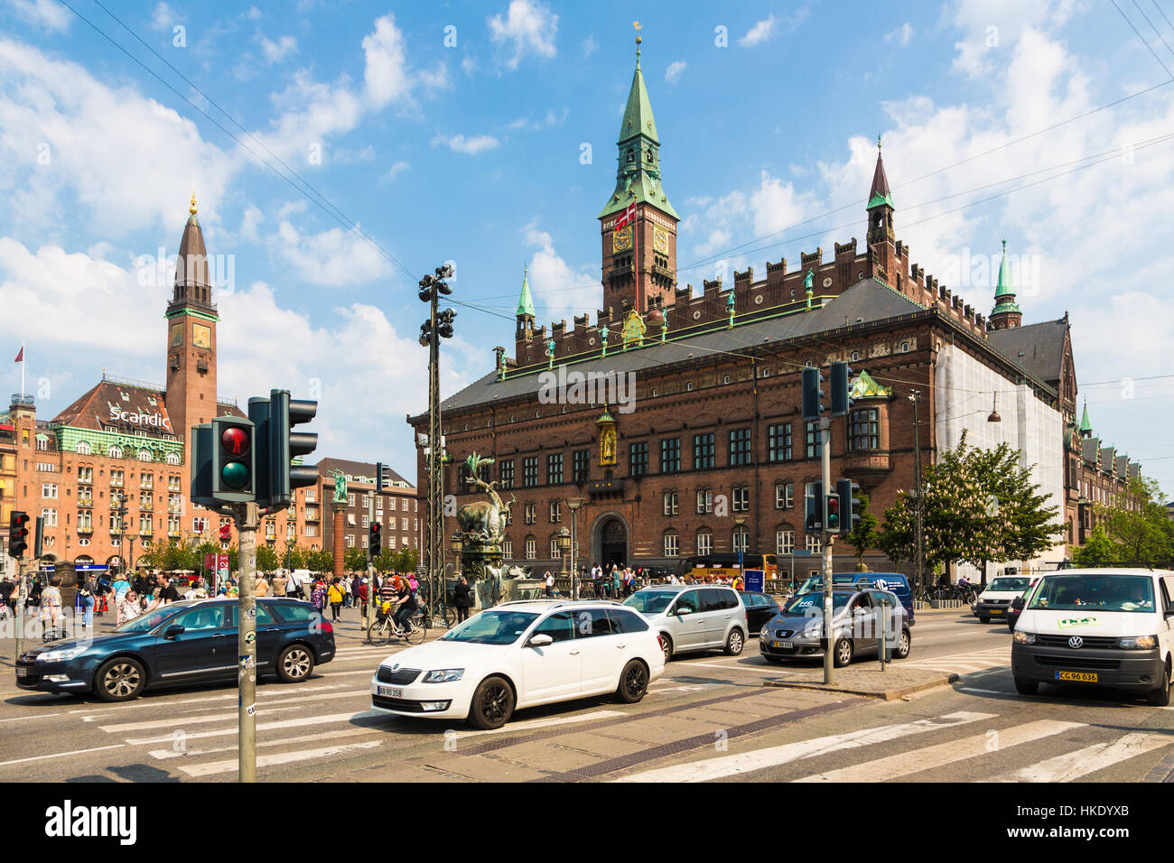 COPENHAGEN, DENMARK - MAY 24, 2016: Cars cross an intersection in front of the city hall in Denmark capital city on a sunny summer day. Stock Photo