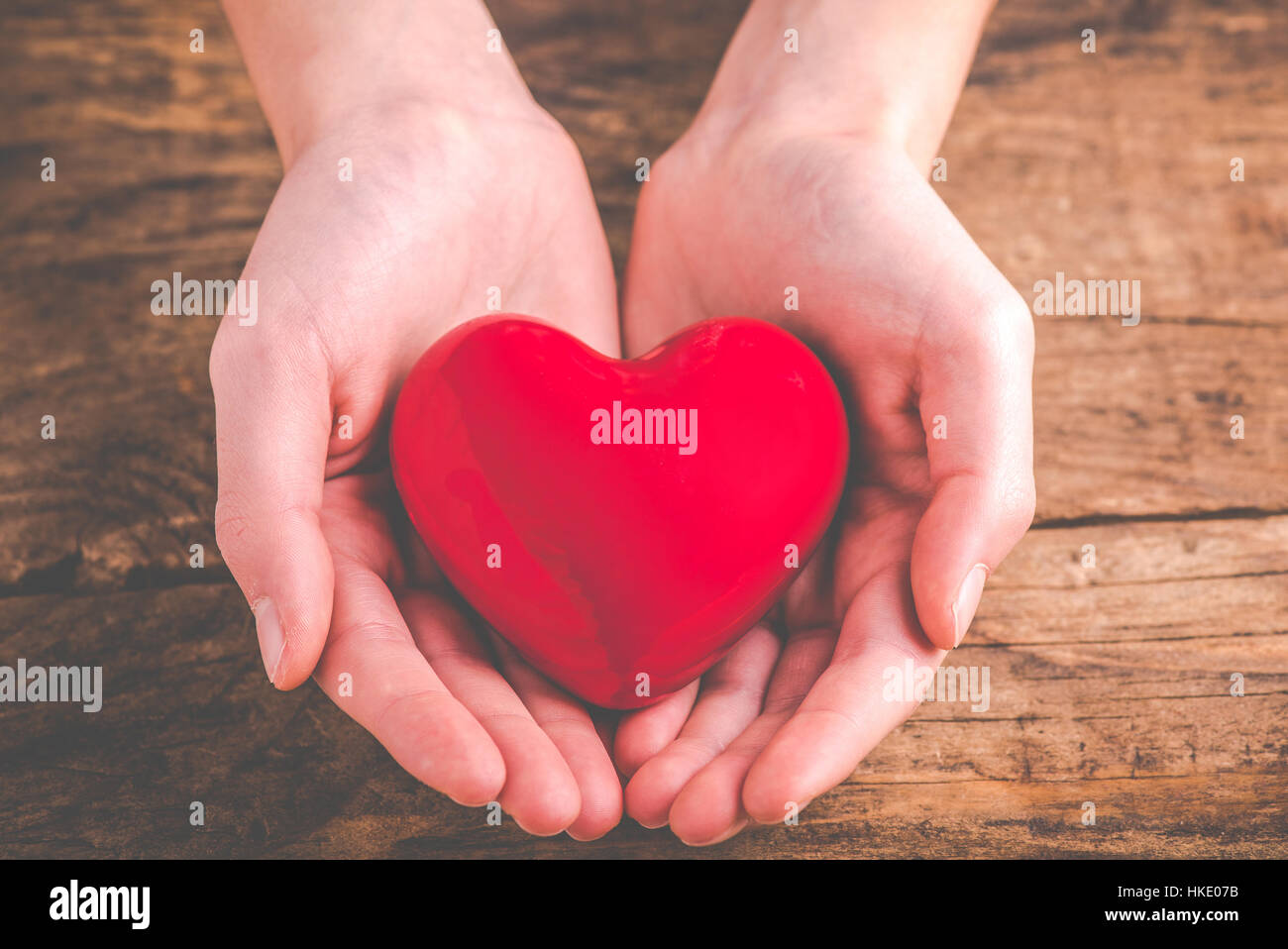 with heart in hands - giving love Stock Photo - Alamy