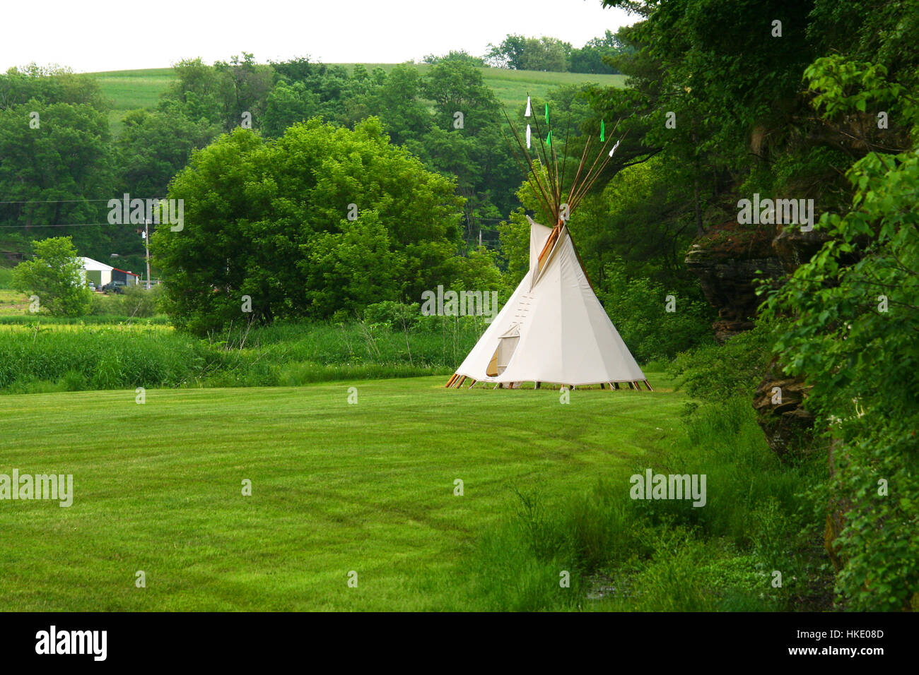 Traditional Native American Tepee or Wigwam erected on a green field lot outside La Prairie in Wisconsin Stock Photo