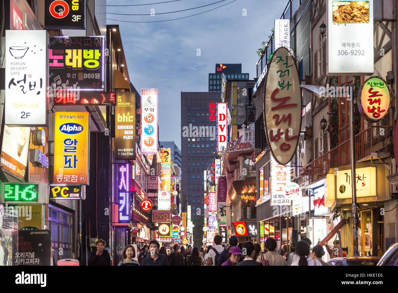 SEOUL, SOUTH KOREA - SEPTEMBER 12 2015: People wander in the walking streets of the Myeong-dong shopping district at night. Stock Photo