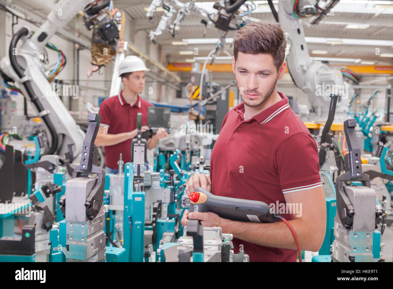 two engineers check functionality while commissioning a production line in welding shop Stock Photo