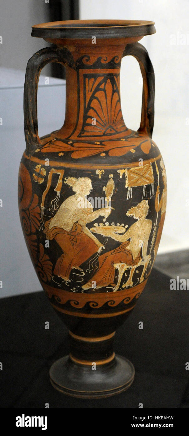 Neck-amphora with red figures decorated with a female figure sitting on a stool holding a plate. At left, woman holding a mirror and, at right, a warrior with helmet, spear, shield and greaves. From Cumae. Painter of New York GR 1000, ca.350-325 BC. Stevens Collection. National Archaeological Museum. Naples. Italy. Stock Photo