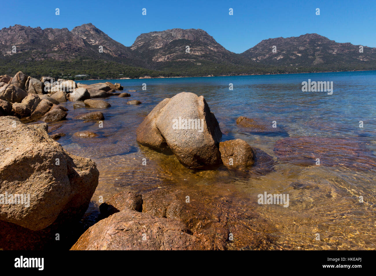 Boats moored in Coles Bay, Tasmania, Australia with the Hazard Mountains behind Stock Photo