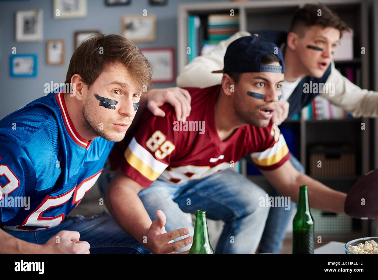 Front view of excited men watching sports game Stock Photo Alamy