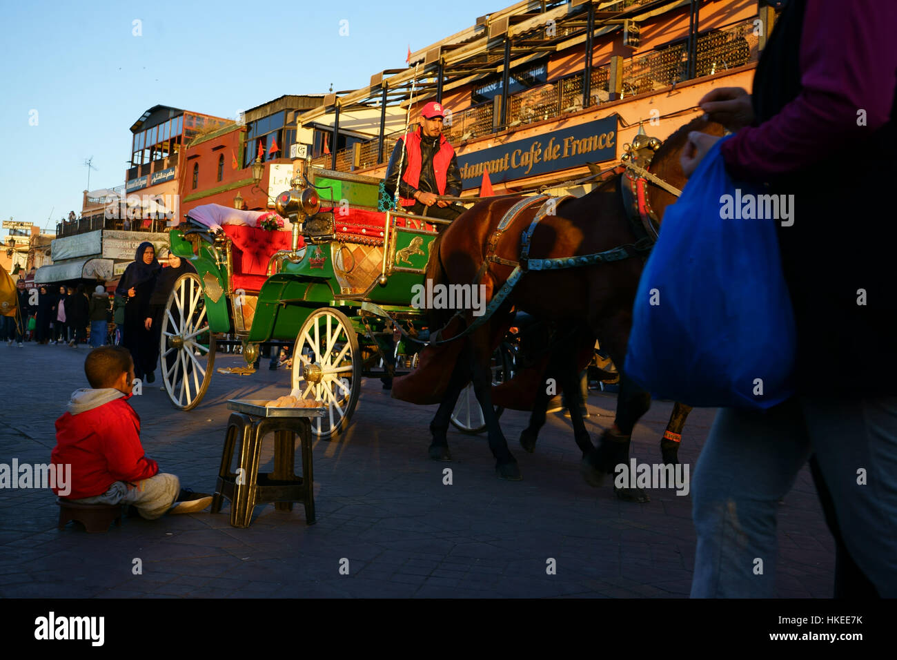 Child street vendor horse stage, Jamaa el-Fna town square, Marrakesh, Marocco Stock Photo