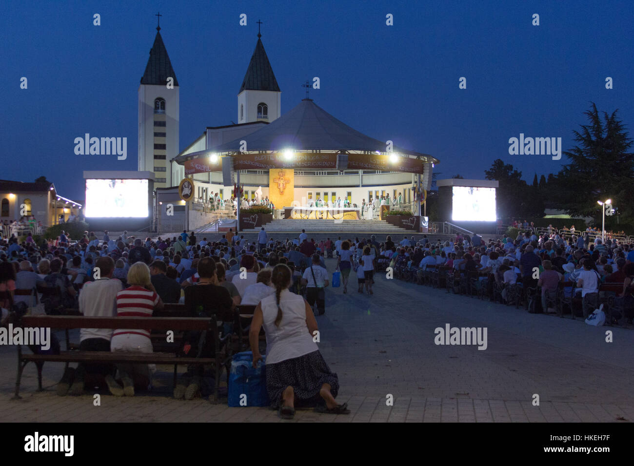 Thousands of pilgrims attending a holy mass and adoration in the evening gathered on the square behind the Saint James church. Stock Photo