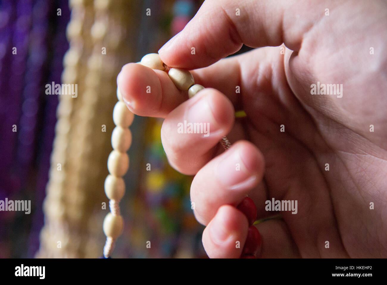 Praying the rosary with the rosary beads in hand Stock Photo