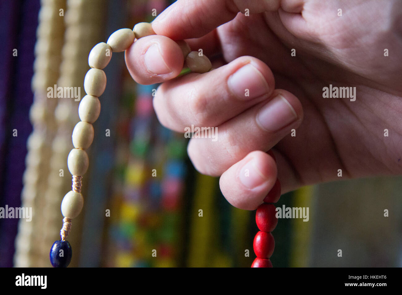 Praying the rosary with the rosary beads in hand Stock Photo