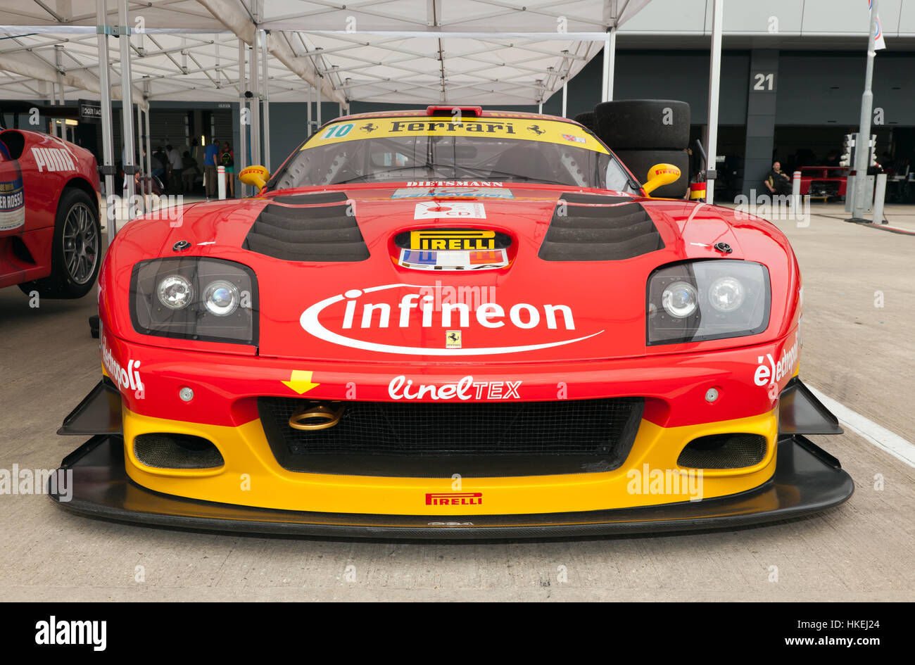 Front view of a  2002, Ferrari 575 GTC Evo race car in the International Paddock at the 2016 Silverstone Classic Stock Photo