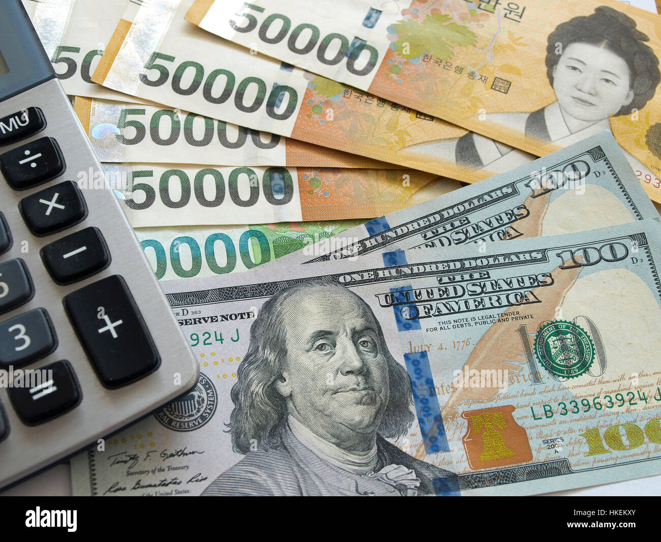 Us One Hundred Dollar And Korean Won Currency With Calculator Stock - 
