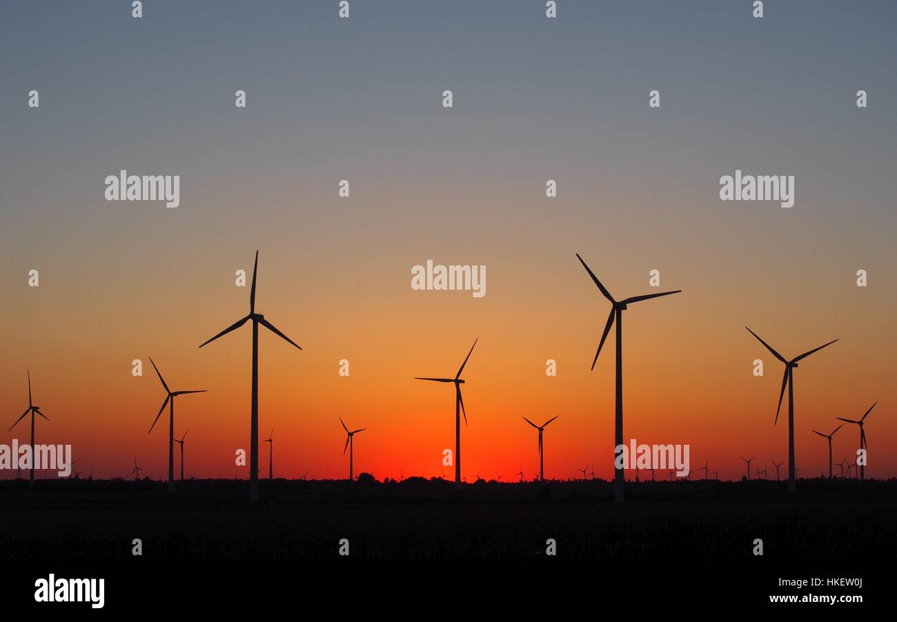 Wind turbines silhouettes on red sky sunset Stock Photo - Alamy