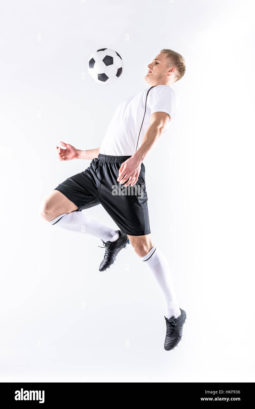 Soccer player exercising with ball Stock Photo