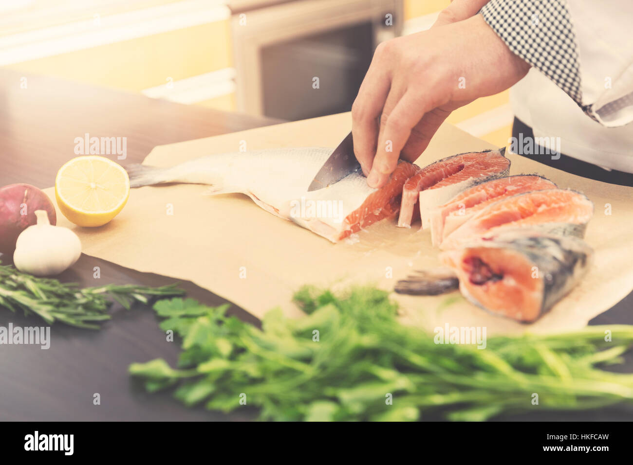 seafood - cook slicing salmon for preparing Stock Photo